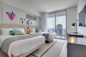 a bedroom with two beds and a large window at Upscale Condo w/ Pool Access in Hyde Beach House! in Hollywood +30 photos