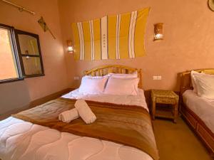 Ένα ή περισσότερα κρεβάτια σε δωμάτιο στο Gite d'étape Asfalou chez l'habitant +49 φωτογραφίες