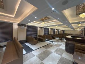 a lobby with a bar and tables and chairs at Hotel Amyra in Kota