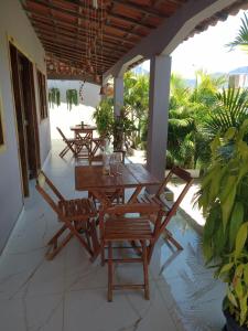 ムクジェーにあるPousada Recanto da Vilaのパティオ(木製のテーブル、椅子付)