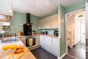 a kitchen with two glasses of orange juice on a counter at Cherry House in Durham