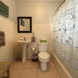 een badkamer met toilet en wastafel bij Ocean Terrace 202 a 4 min walk to Sandy Beach in Aguada