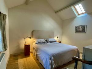 a bedroom with a large white bed with a window at 1 Bed in Ullswater 94064 in Watermillock