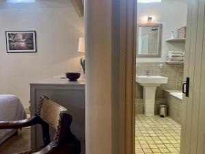 a bathroom with a sink and a toilet and a chair at 1 Bed in Ullswater 94064 in Watermillock +13 photos
