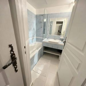 a bathroom with a sink and a tub and a mirror at Domaine de Fayence in Fayence