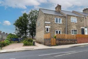 a brick house on the side of a street at *Discounts/Contractors/WIFI/Free Parking/Smart TV in Durham