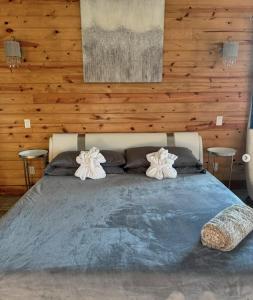 a bedroom with a large bed with two pillows at Private Retreat with Pond, Pool and Hot Tub in Boyd