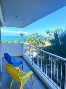 a balcony with two chairs and a view of the ocean at Oceanfront Isla Verde 2B 2B Apartment Paradise Getaway in San Juan