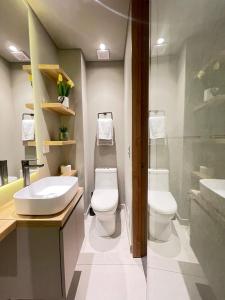 a bathroom with a sink and a toilet and a shower at Luxury Loft in Bogotá