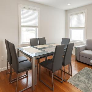 a dining room with a table with chairs and a couch at Adam's apartment Modern 3BR 2BA Free Parking by Swampscott Beach By Amana Green realty in Swampscott