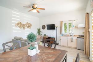 a living room with a ceiling fan and a table at Casa Loba Suite 1 with an outdoor tub in Rincon