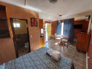 a bedroom with a bed and a room with a table at Cerros Azules in Trapiche +33 photos