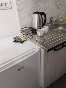 a kitchen with a sink and a coffee pot on a counter at Valencia in Vršac +10 photos