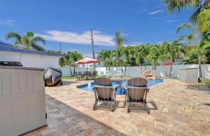 a patio with a table and chairs and a pool at Aquaria in Fort Lauderdale