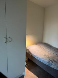 a small bedroom with a bed and a closet at Aurora view apartment III - close to everything in Tromsø