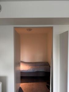 a bedroom with a bed in a small room at Aurora view apartment III - close to everything in Tromsø