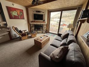 a living room with a couch and a fireplace at Summit House East 1 Bed Loft 2 Bath SHMB in Wheeler Junction