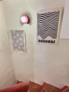 a sign on the wall of a room with a wave at Le chateau de ma mère- climatisé -duplex- 4 personnes in Aubagne