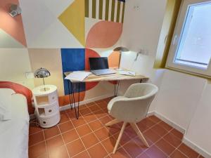 a room with a desk with a laptop and a chair at Le chateau de ma mère- climatisé -duplex- 4 personnes in Aubagne