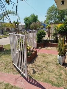 a white fence in a yard with plants at Tote Esquina in Esquina +11 photos