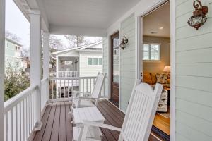 a porch with two white chairs and a couch at 410A The Jetty House in Virginia Beach