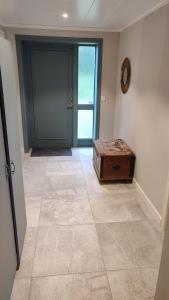 an empty hallway with a door and a wooden trunk at Skutviken in Henån