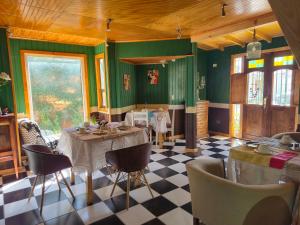 a dining room with green walls and a table and chairs at Hotel de los Castillos in Puerto Natales