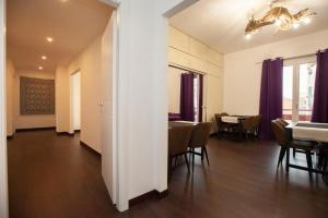 a living room with a table and a dining room at Eva Luxury Saint Remy in Cagliari