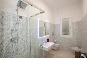 a bathroom with a shower and a toilet and a sink at Eva Luxury Saint Remy in Cagliari +15 photos