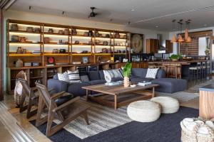 a living room with a couch and a table at Los Veneros Punta de Mita - Pacific Tower in Punta Mita