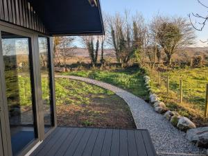 a porch of a house with a view of a field at Tranquil Off-Grid Cabin in Ballina