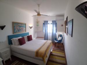 a bedroom with a bed and a chair in it at Casa De Terena in Terena +40 photos