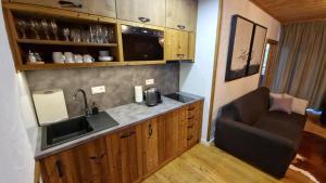 a small kitchen with a sink and a chair at Apartment ABAKUS with jacuzzi & sauna in Demanovska Dolina