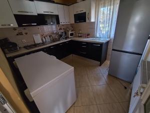 a small kitchen with a white refrigerator and a counter at La Elias in Breb +5 photos