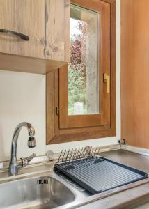 a kitchen sink with a drying rack on top of it at Casa Los Altos de Santiago in Villanúa