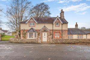 a large brick house with a stone wall at 3 Bed in Mealsgate oc-e33626 in Mealsgate