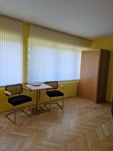a waiting room with a table and two chairs at Penzion BránaBeskyd in Frýdlant nad Ostravicí