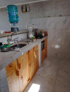 uma cozinha com pia e fogão em Pousada degamix em Barroquinha