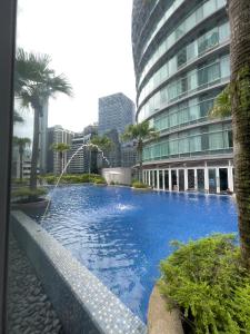 a large swimming pool in front of a building at Vortex Suites KLCC By GuestHouse in Kuala Lumpur