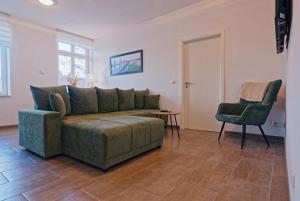 a living room with a couch and a chair at Modern family apartment in Bamberg in Bamberg