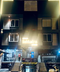 a building with stairs and a sign on it at Singh Hotel's Shubhadra Guest House in Mathura