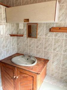 a bathroom with a sink and a mirror at Field's End in Howick