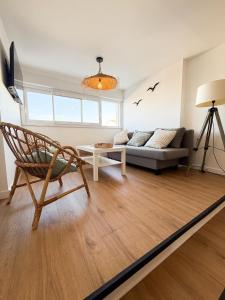 a living room with a couch and a chair at Cozy T2 - L'Herbaudière - 200m de la plage in Noirmoutier-en-l'lle