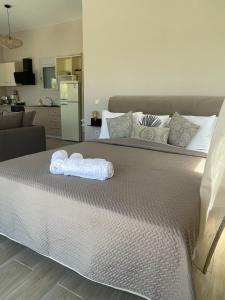 a bed with two towels sitting on top of it at BEACH WHTE VILLAs one bedroom in Minia