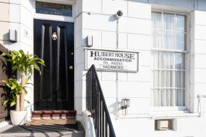 a black door to a house with a sign on it at Hubert House in Dover