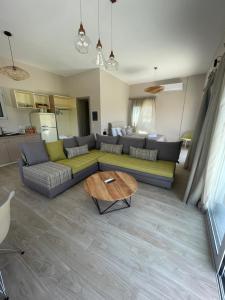 a living room with a couch and a table at BEACH WHTE VILLAs one bedroom in Minia