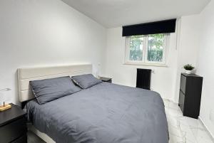 a bedroom with a large bed and a window at Casa Rossini - Moderno appartamento a due passi dal mare in Pescara