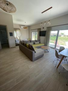 a living room with a couch and a table at BEACH WHTE VILLAs one bedroom in Minia