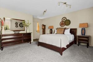 a bedroom with a bed and a dresser and a television at Kaibab - Adobe Village condo - 2 bedroom in Oak Creek