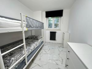 a bedroom with two bunk beds and a counter at Casa Rossini - Moderno appartamento a due passi dal mare in Pescara +4 photos